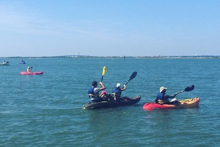 a group of people in a small boat in a body of water